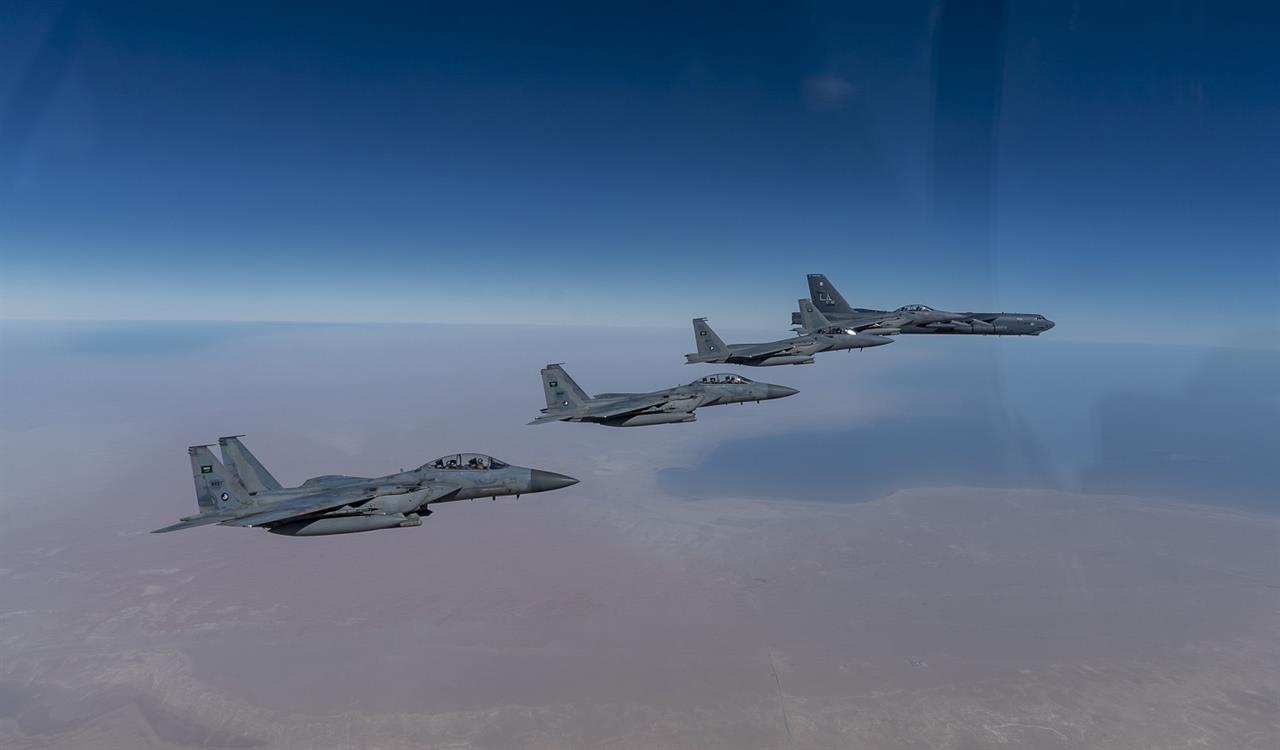 In this Wednesday, Jan. 27, 2021 handout photo, released by the U.S. Air Force, a B-52 bomber from the 2nd Bomb Wing of Barksdale Air Force Base in Louisiana, right, flies with Royal Saudi Air Force F-15s during a mission in the Middle East. The U.S. military said Wednesday it again flew a B-52 bomber over the Middle East "to deter potential aggression" amid tensions with Iran. (U.S. Air Force/Senior Airman Roslyn Ward, via AP)