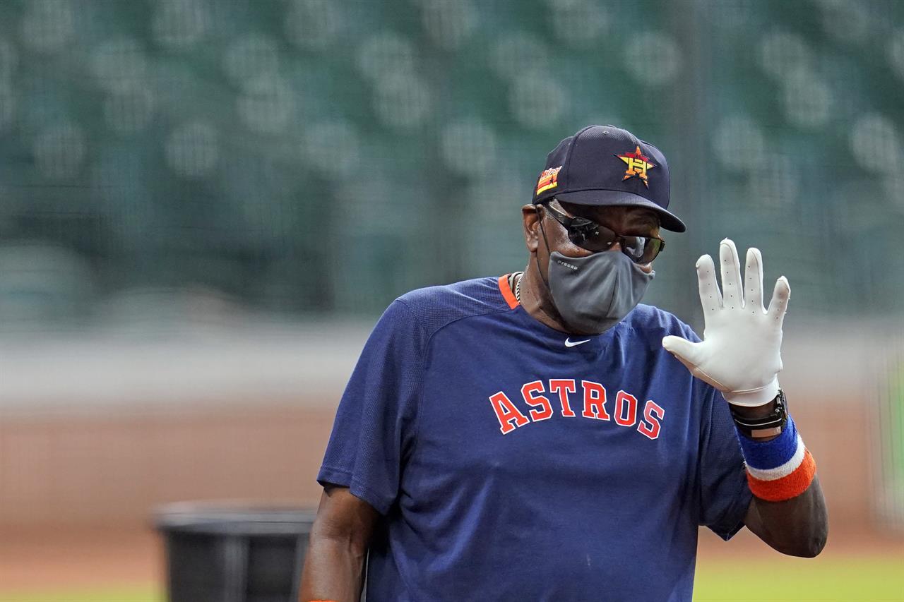 FILE - Houston Astros manager Dusty Baker gestures during a baseball practice at Minute Maid Park in Houston, in this Saturday, July 4, 2020, file photo. Astros manager Dusty Baker said he had been vaccinated against COVID-19 as the team began spring training Thursday, Feb. 18, 2021. (AP Photo/David J. Phillip, File)