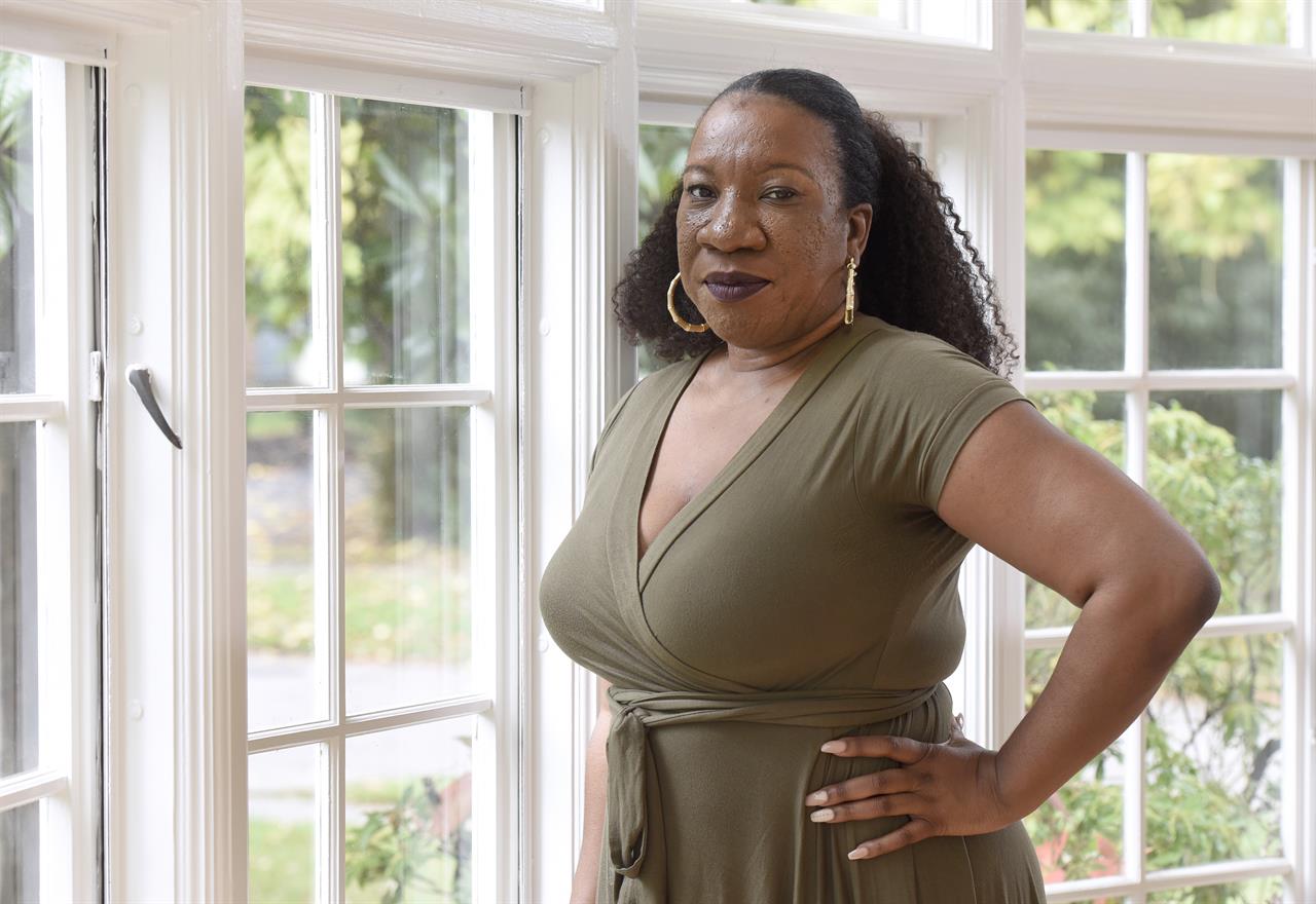 Tarana Burke, founder and leader of the #MeToo movement, stands in her home in Baltimore on Oct. 13, 2020. A coalition of three groups vital to the #MeToo movement is collaborating on an initiative to focus on a population that has often felt left out of the conversation: Black survivors of sexual violence. It's been more than three years since the #MeToo movement exploded into view, but Burke, the activist who gave the movement its name, says concrete change has been incremental at best — even more so for the Black community. (AP Photo/Steve Ruark, file)