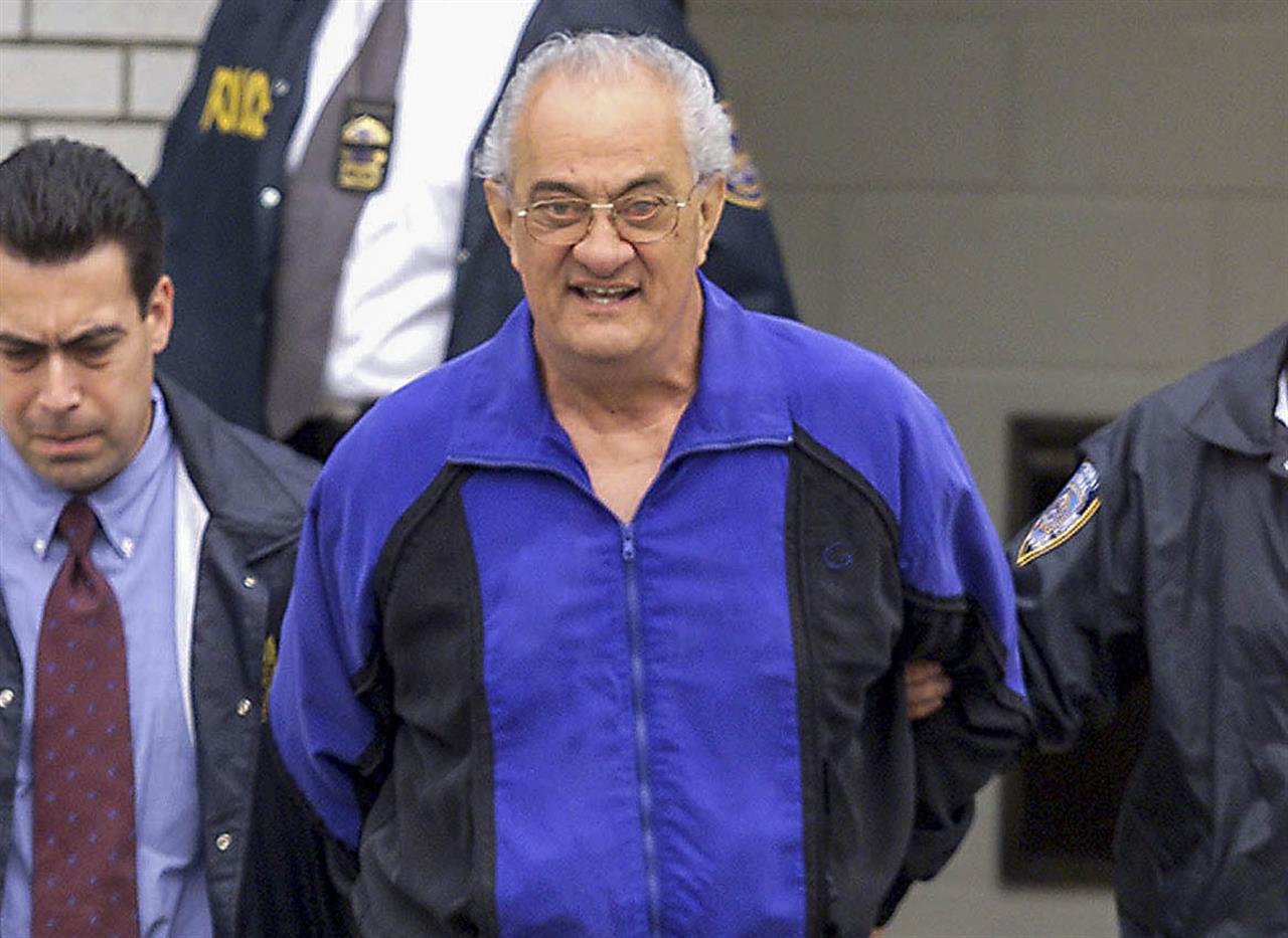 FILE - In this June 4, 2002, file photo, Peter Gotti, center, is escorted out of the Waterfront Commission following his arrest in the Brooklyn borough of New York. Gotti, the brother of notorious Gambino crime boss John Gotti, has died while serving a federal prison sentence, a person familiar with the matter told The Associated Press on Thursday, Feb. 25, 2021. Gotti, 81, died of natural causes while incarcerated at the Federal Medical Center in Butner, N.C., said the person, who could not discuss the matter publicly and spoke to the AP on condition of anonymity. (Mike Albans/The Daily News via AP, File)