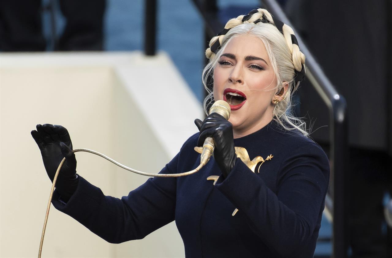 FILE - In this Wednesday, Jan. 20, 2021 file photo, Lady Gaga sings the national anthem during President-elect Joe Biden's inauguration at the U.S. Capitol in Washington. Lady Gaga's two French bulldogs, which were stolen by thieves who shot and wounded the dogwalker, were recovered unharmed Friday, Feb. 26, 2021 Los Angeles police said.(AP Photo/Saul Loeb, Pool)