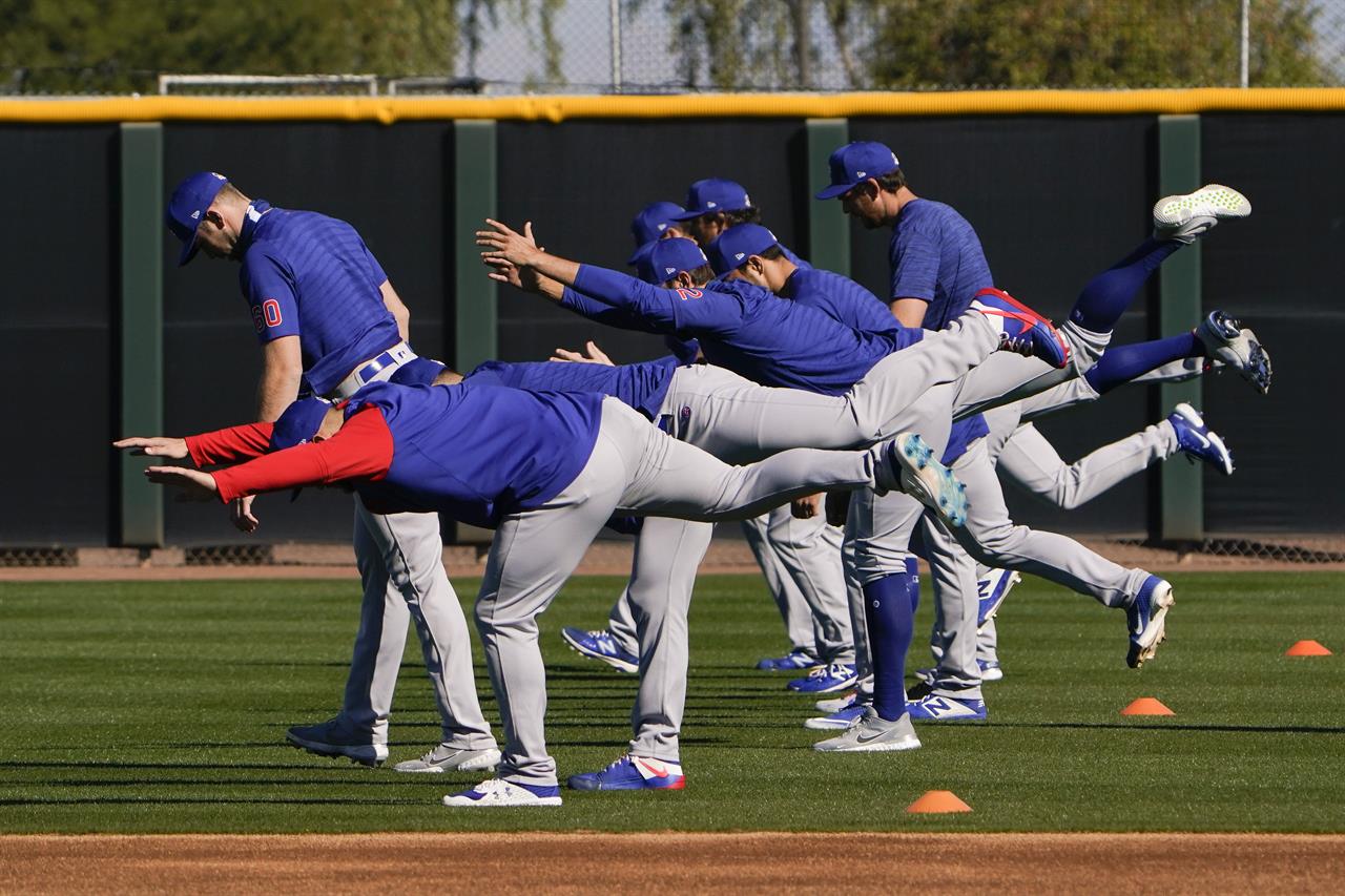 Chicago Cubs pitchers warm up during a spring training baseball workout in Mesa, Ariz., Monday, Feb. 22, 2021. (AP Photo/Jae C. Hong)