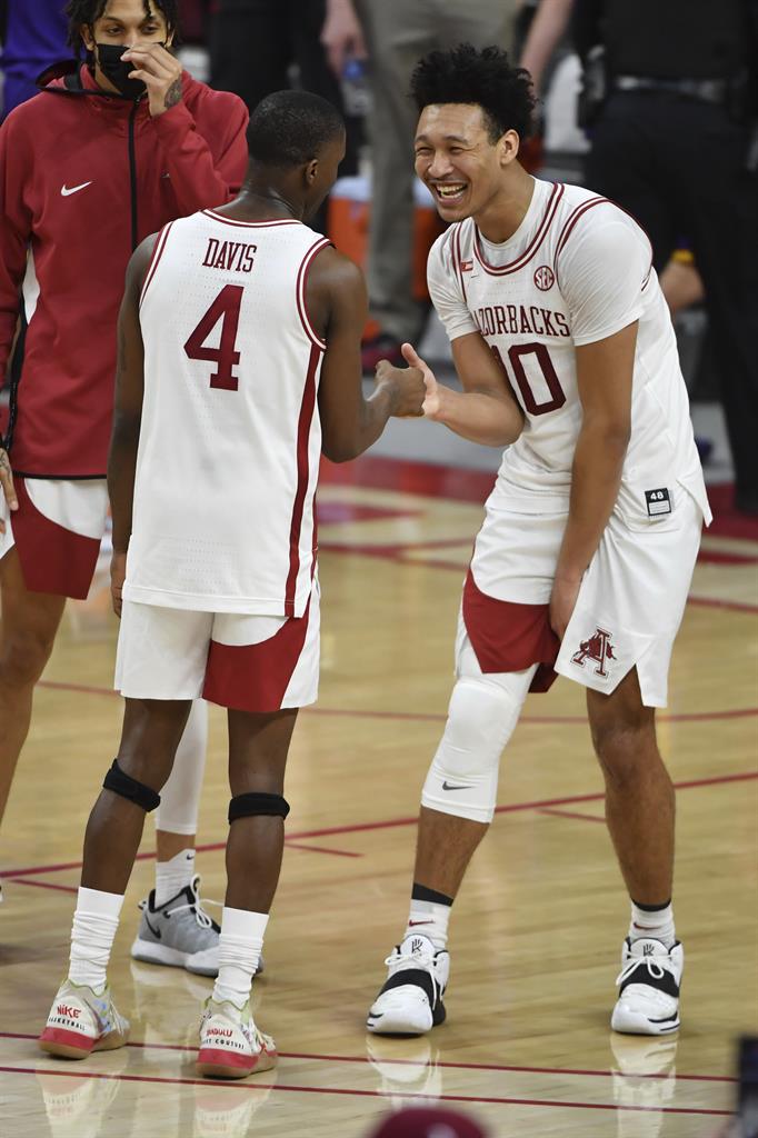 Arkansas players Davonte Davis (4) and Jaylin Williams (10) celebrate after defeating LSU during an NCAA college basketball game in Fayetteville, Ark. Saturday, Feb. 27, 2021. (AP Photo/Michael Woods)