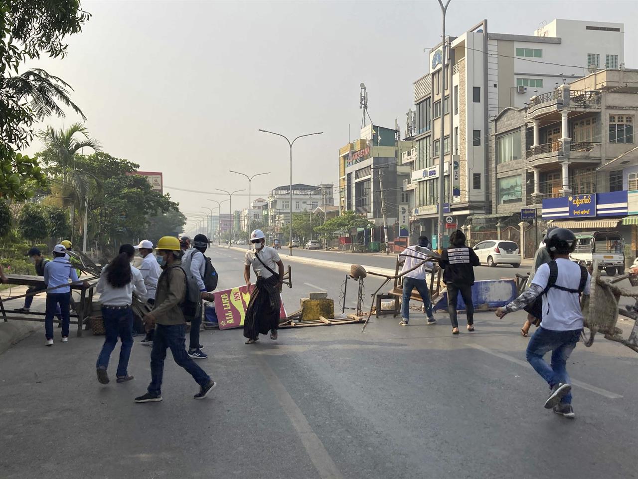 Protesters block a main road during a protest against the military coup in Mandalay, Myanmar, Sunday, Feb. 28, 2021. Police in Myanmar escalated their crackdown on demonstrators against this month's military takeover, deploying early and in force on Saturday as protesters sought to assemble in the country's two biggest cities and elsewhere. (AP Photo)