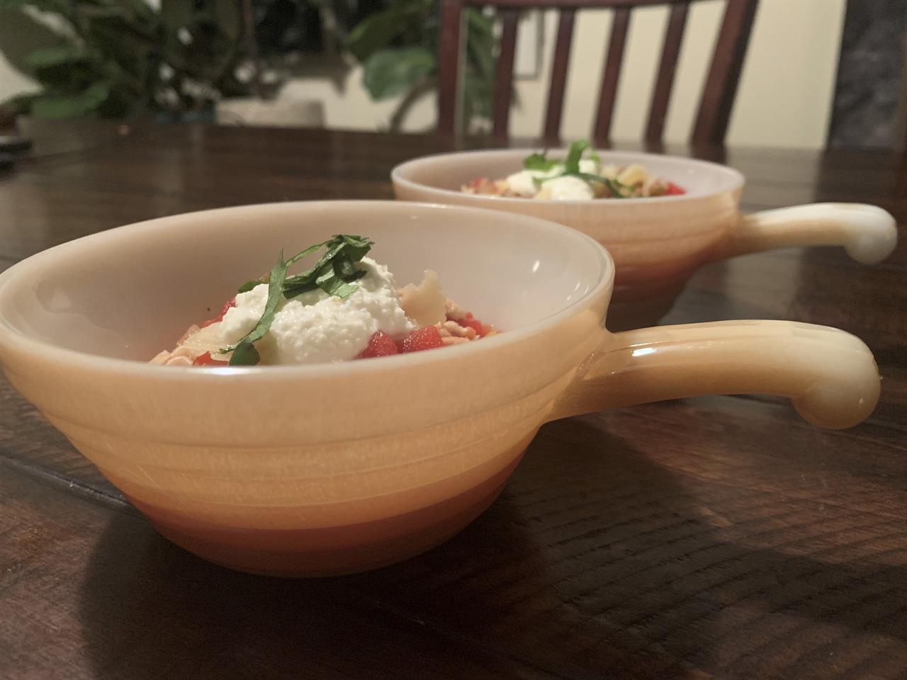 This image provided by Tracee Herbaugh depicts two vintage peach lustre Fire King chili bowls. There are lustrous chili bowls with handles, stackable refrigerator boxes, and casserole dishes set on top of brass candle warmers. These are durable dishes, often smaller than modern serving pieces, that can go from freezer to oven to table. But collectors usually acquire them for enjoyment, not utility. (Tracee Herbaugh via AP)