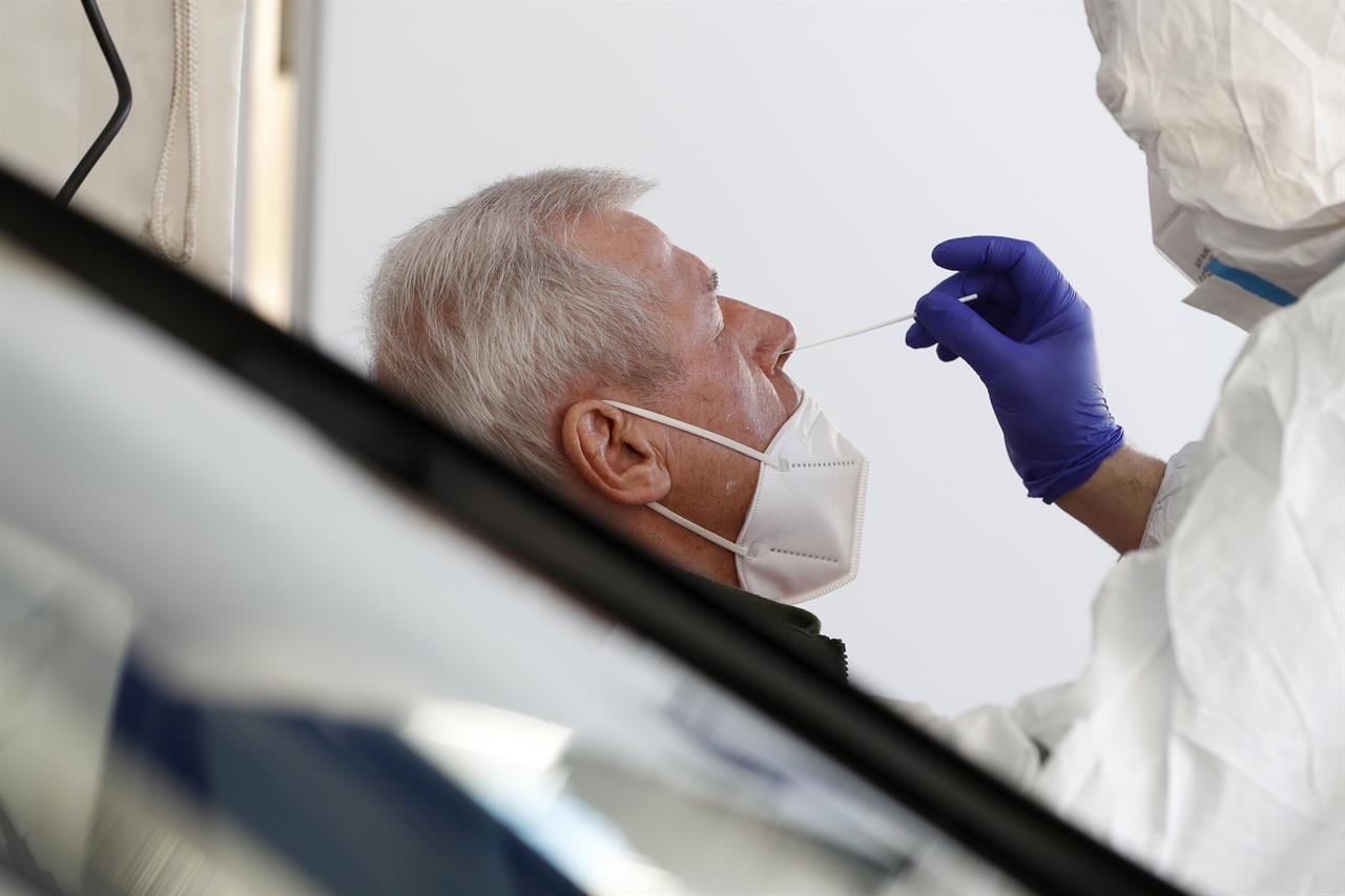 A German help worker tests a French resident working in Germany for COVID-19 at the German-French border near Saarbrucken, Tuesday, March 2, 2021. Germany announced Sunday that travelers from France's northeastern Moselle region will face additional restrictions because of the high rate of variant coronavirus cases there. Travelers from this area must produce a recent negative coronavirus test before entering Germany. The Moselle region in northeastern France includes the city of Metz and borders the German states of Saarland and Rhineland-Palatinate. (AP Photo/Jean-Francois Badias)
