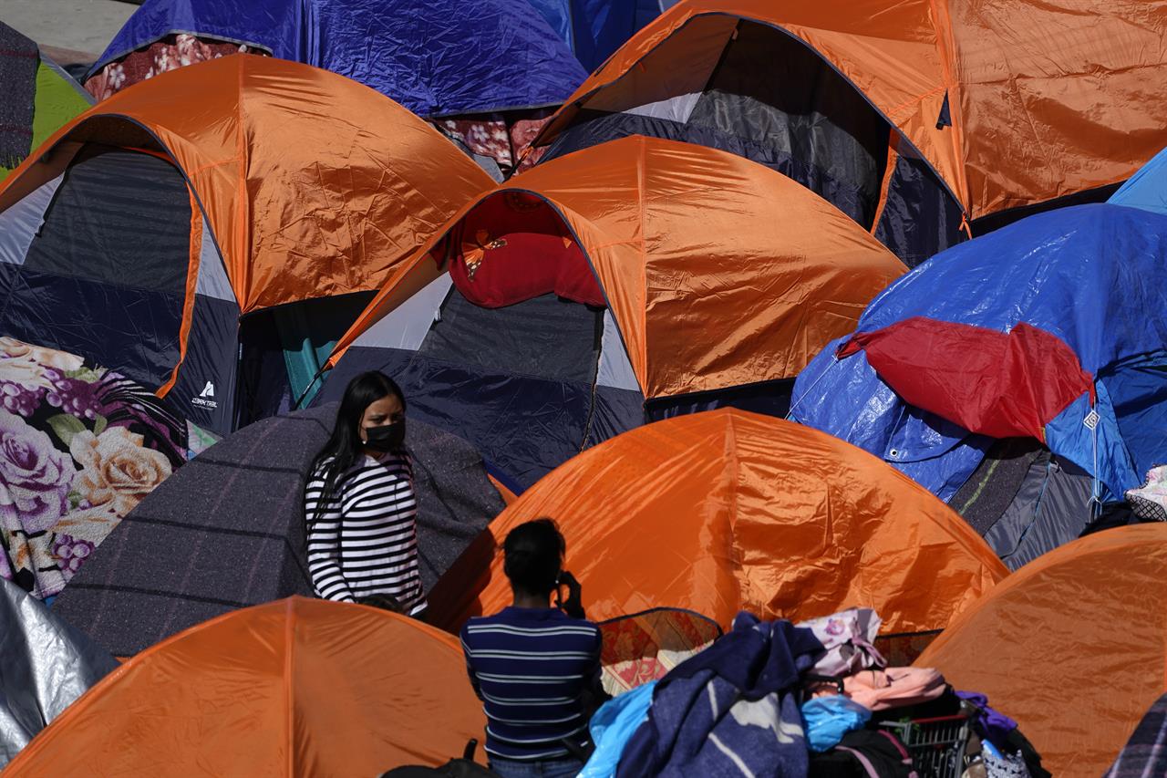 Tents used by migrants seeking asylum in the United States line an entrance to the border crossing, Monday, March 1, 2021, in Tijuana, Mexico. President Joe Biden is holding a virtual meeting with Mexican President Andrés Manuel López Obrador. Monday's meeting was a chance for them to discuss migration, among other issues. (AP Photo/Gregory Bull)