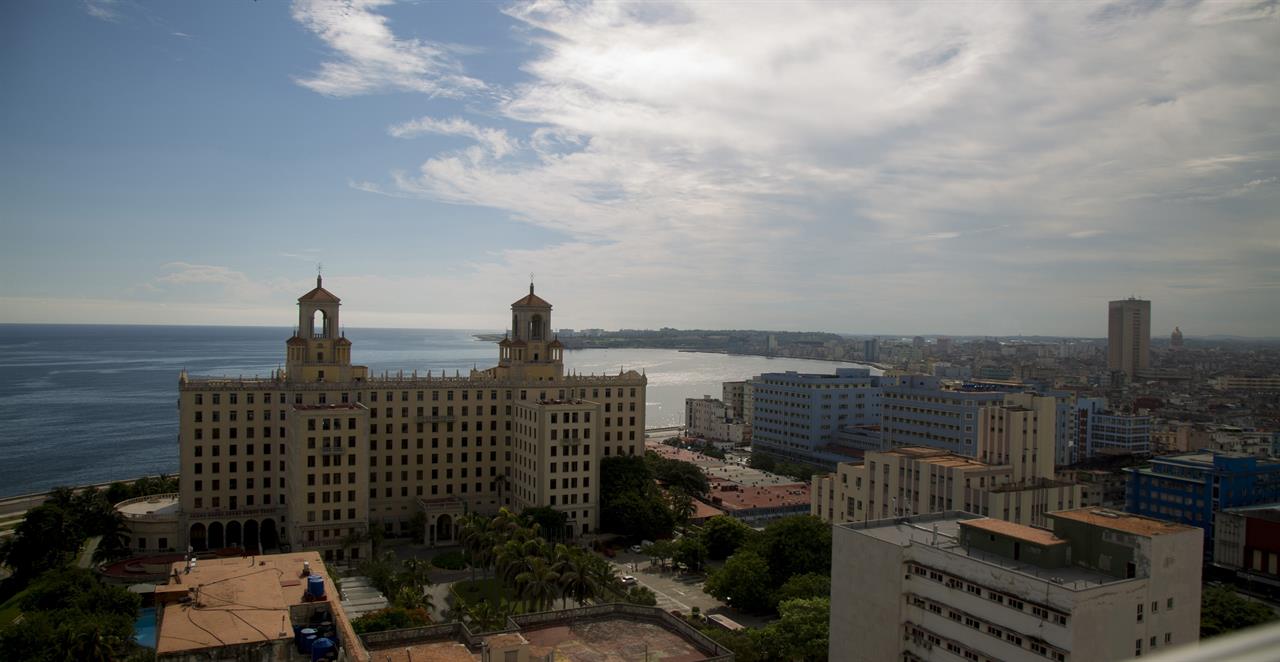 FILE - In this June 17, 2020, file photo, the Hotel Nacional stands devoid of tourists during the new coronavirus pandemic in Havana, Cuba. The Caribbean is hunting for visitors and vaccines to jump-start the stalled economy in one of the world’s most tourism-dependent regions. (AP Photo/Ismael Francisco, File)