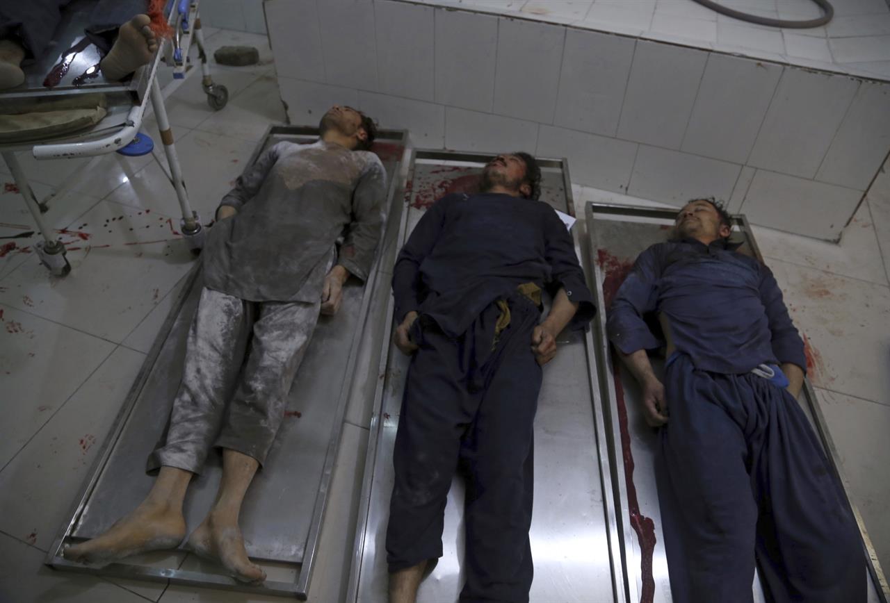 EDS NOTE: GRAPHIC CONTENT - The bodies of Afghan civilians, who were killed by unknown gunmen at a plaster factory overnight, lie in a hospital morgue in Jalalabad, Nangarhar, east of Kabul, Afghanistan, Thursday, March 4, 2021. The victims were Hazaras, members of Afghanistan's minority Shiite community. (AP Photo)