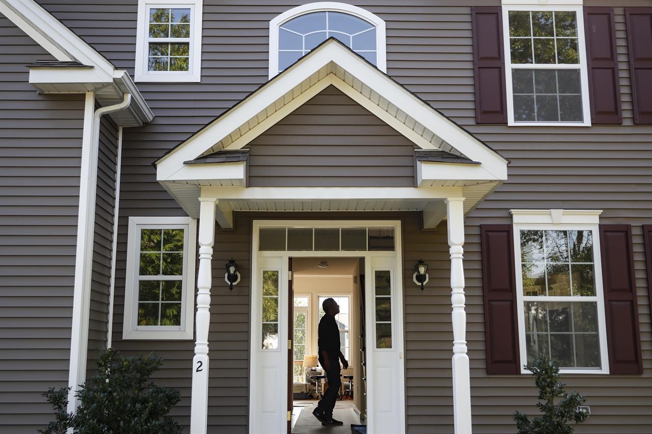 FILE - In this July 21, 2020, file photo, a homeowner tours their new home, in Washingtonville, N.Y. Experienced agents are all too familiar with the misconceptions people have about insurance. For example, many people don’t realize that a homeowners policy won’t cover damage from flooding, earthquakes or everyday wear and tear. (AP Photo/John Minchillo, File)