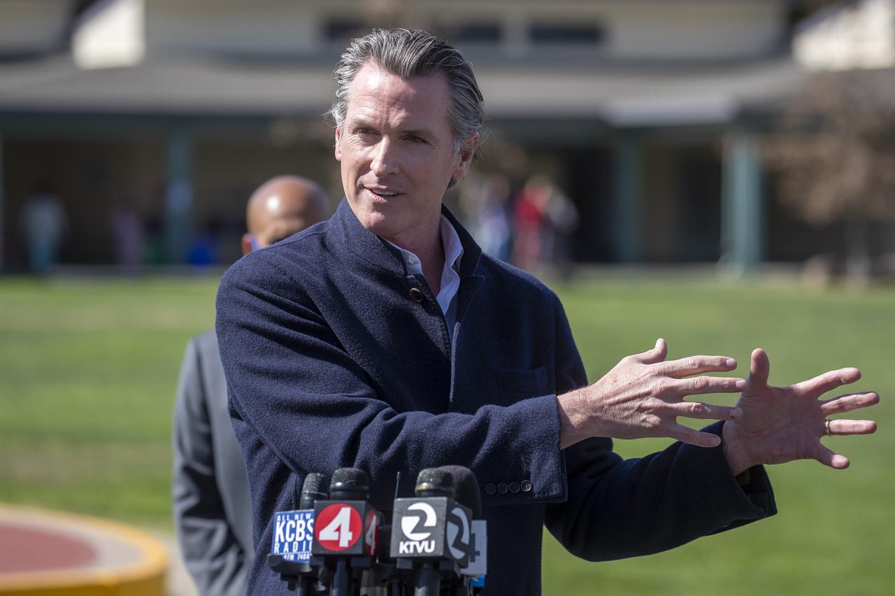 California Gov. Gavin Newsom speaks about the state's plan to reopen schools as coronavirus vaccinations continue during a news conference on the school yard at Barron Park Elementary in Palo Alto, Calif., Tuesday, March 2, 2021. (Karl Mondon/Bay Area News Group via AP)