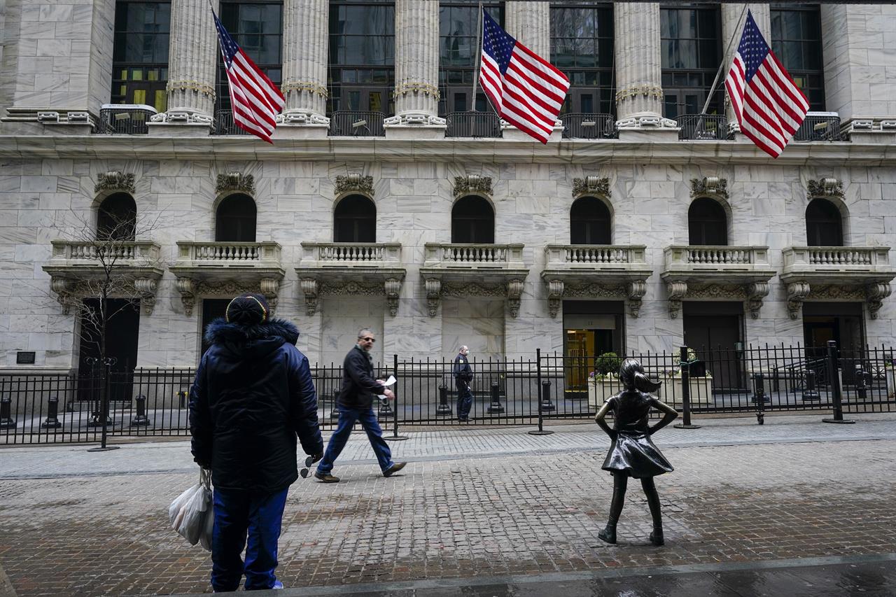 FILE - Pedestrians pass the New York Stock Exchange Tuesday, Feb. 16, 2021, in New York. Stocks are opening broadly higher on Wall Street as investors welcome news that hiring by U.S. employers picked up last month at the fastest pace since October. The S&P 500 added 0.5% in the early going Friday; March 5, however the benchmark index is still on track for its third weekly loss in a row. (AP Photo/Frank Franklin II, File)