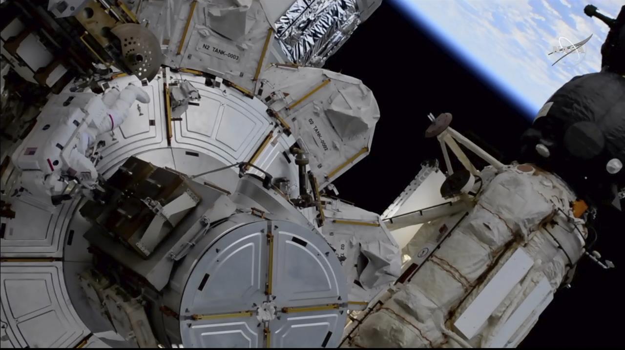 This photo provided by NASA shows US astronaut Kate Rubins outside the International Space Station during a space walk on Friday, March 5, 2021. Rubins and Japan's Soichi Noguchi floated outside to complete unfinished work from Sunday's spacewalk. More mounting brackets and struts need to be installed for new and improved solar panels due to arrive in June. (NASA via AP)