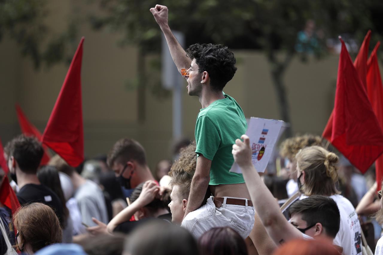 A man rides on the shoulders of another as hundreds of protesters march in Sydney, Saturday, March 6, 2021, ahead of the annual Gay and Lesbian Mardi Gras. The protesters say they want to restore the protest roots of Mardi Gras and challenge systems of injustice. (AP Photo/Rick Rycroft)