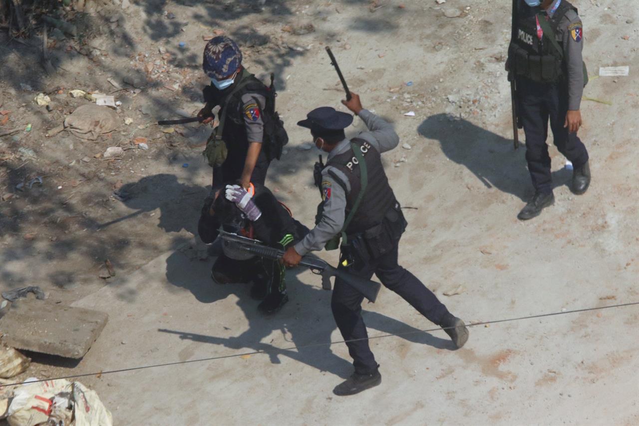 Riot police officers hold down a protester as they disperse protesters in Tharkata Township on the outskirts of Yangon, Myanmar, Saturday, March 6, 2021. The U.N. special envoy for Myanmar on Friday called for urgent Security Council action, saying multiple peaceful protesters were killed and injured in the military's worst crackdowns this week. (AP Photo)
