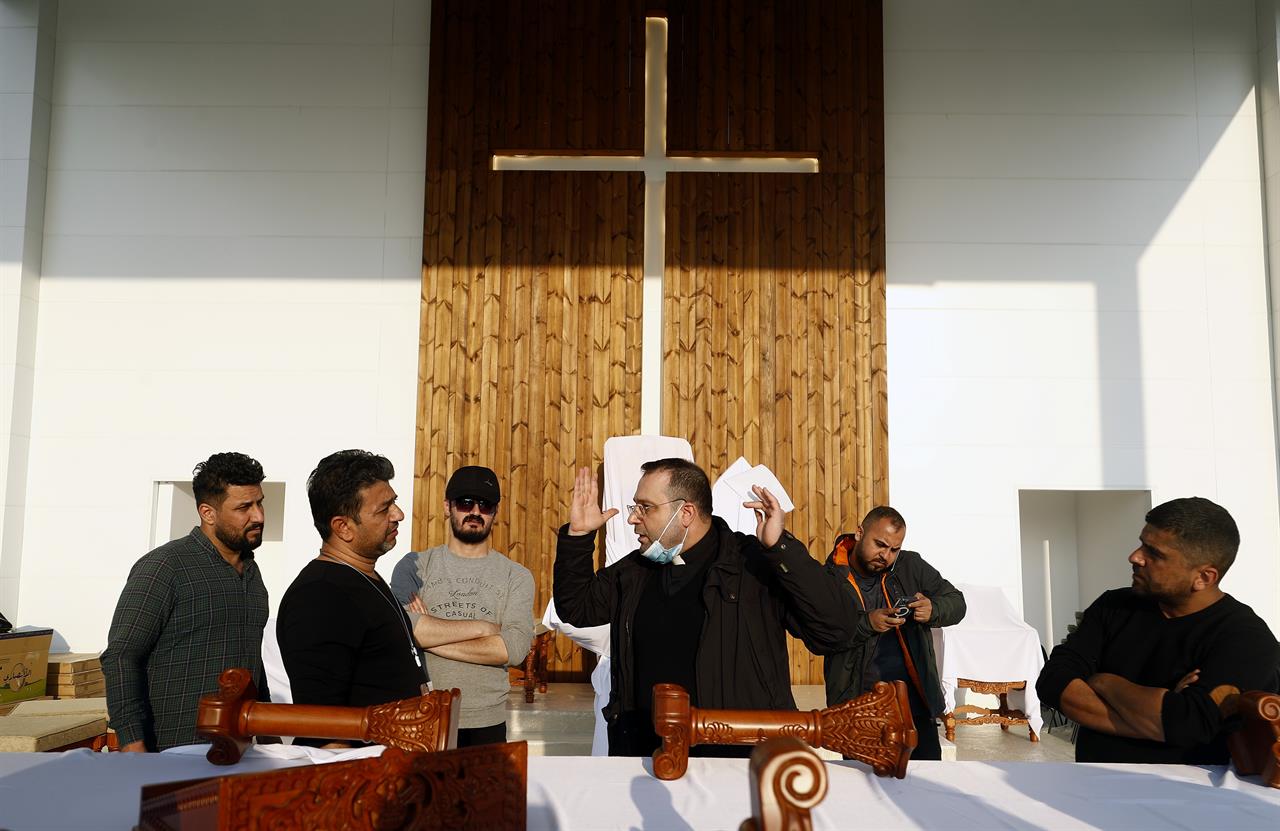 Iraqi Christians talk during preparations before Pope Francis visit at the main stadium in Irbil, Iraq, Saturday, March 6, 2021. Earlier today Francis met privately with the country's revered Shiite leader, Grand Ayatollah Ali al-Sistani. (AP Photo/Hadi Mizban)