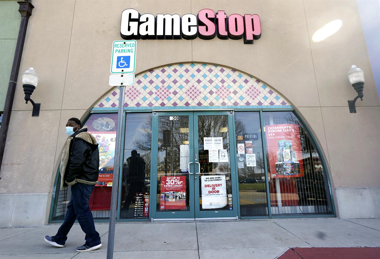 FILE - In this Jan. 28, 2021 file photo, a pedestrian passes a GameStop storefront in Dallas. GameStop shares jumped around 12% in premarket trading Monday, March 8 after the video game retailer appointed a committee it said would aim to “transform GameStop into a technology business.” (AP Photo/LM Otero, File)