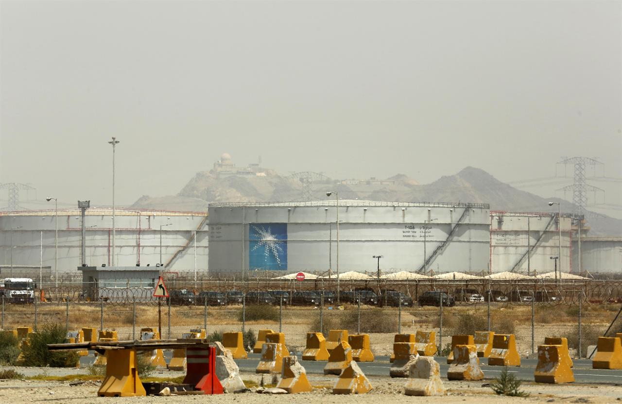 Storage tanks are seen at the North Jiddah bulk plant, an Aramco oil facility, in Jiddah, Saudi Arabia, Sunday, March 21, 2021. Saudi Arabia’s state-backed oil giant Aramco announced Sunday that its profits nearly halved in 2020 to $49 billion, a big drop that came as the coronavirus pandemic roiled global energy markets. (AP Photo/Amr Nabil)