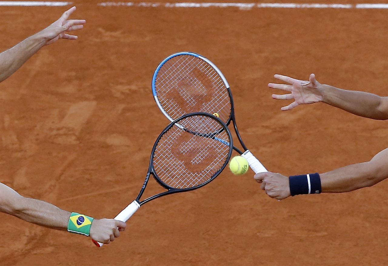 FILE - In this file photo dated Saturday, Oct. 10, 2020, Croatia's Mate Pavic, right, and Brazil's Bruno Soares play a shot in the men's doubles final match of the French Open tennis tournament at the Roland Garros stadium in Paris, France. The 2021 French Open schedule is being disrupted by the coronavirus pandemic for the second year in a row, as organizers said Thursday April 8, 2021, the Grand Slam tournament will be delayed by one week because of surging virus cases in France.(AP Photo/Michel Euler, FILE)